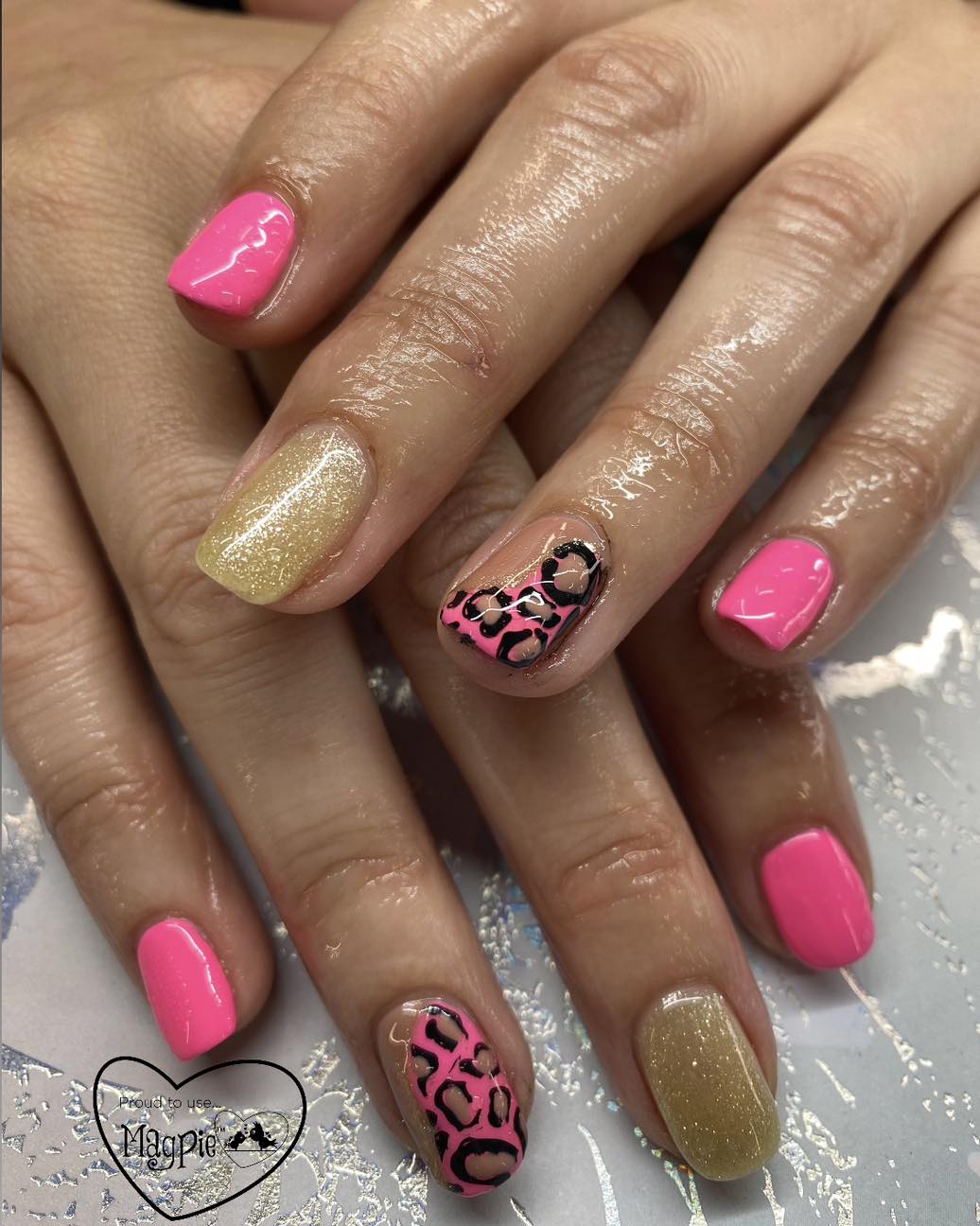 Pink and gold glitter nails with leopard print accents