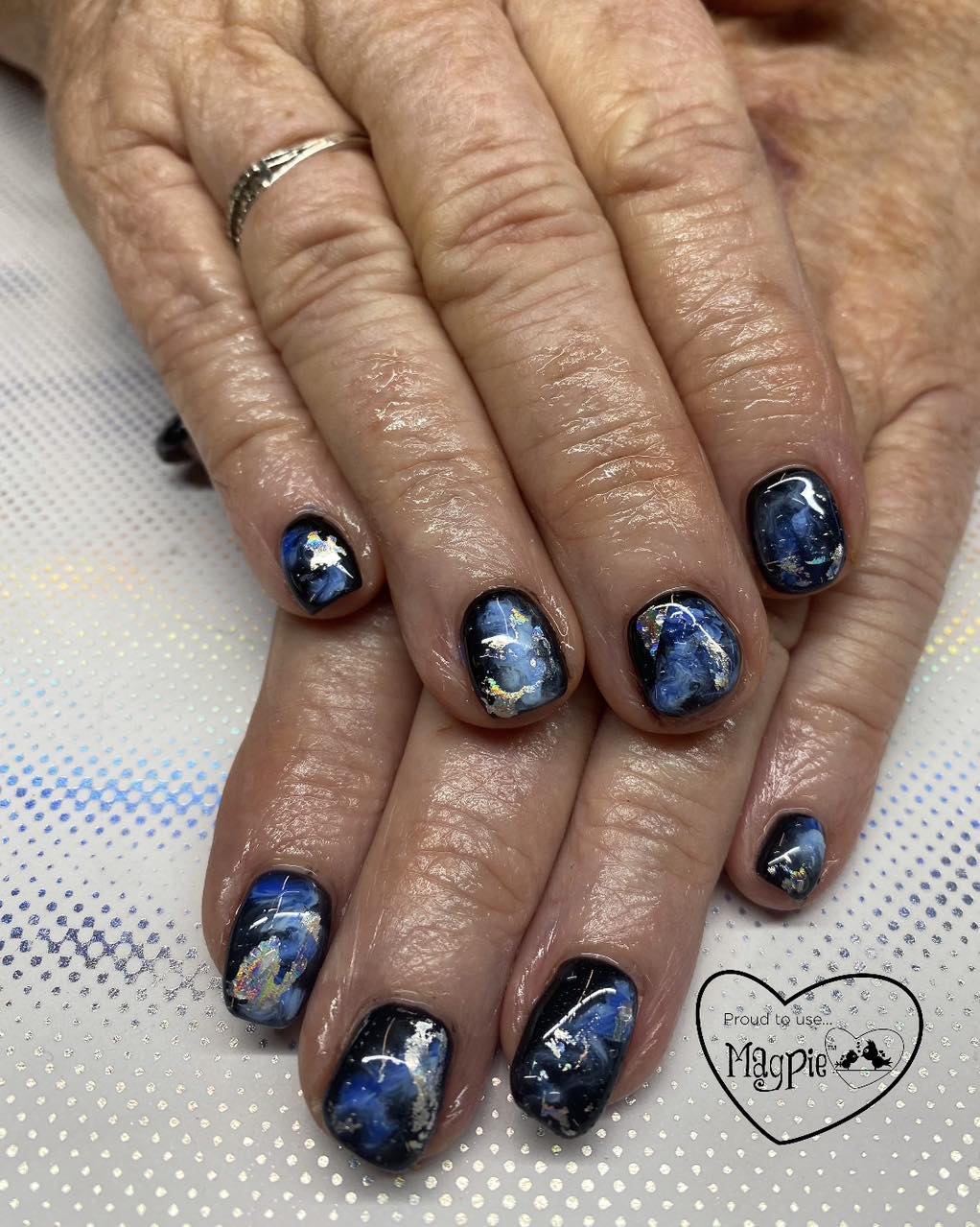 Navy marble gel nails with silver foil