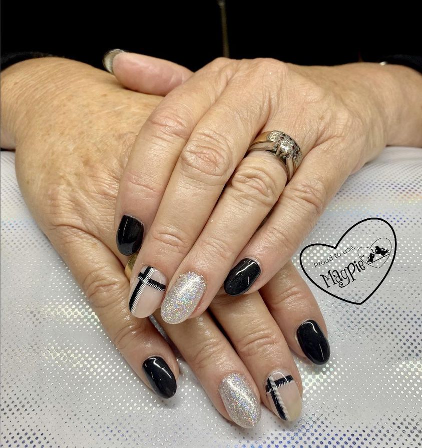Black and holographic glitter nails with plaid accents