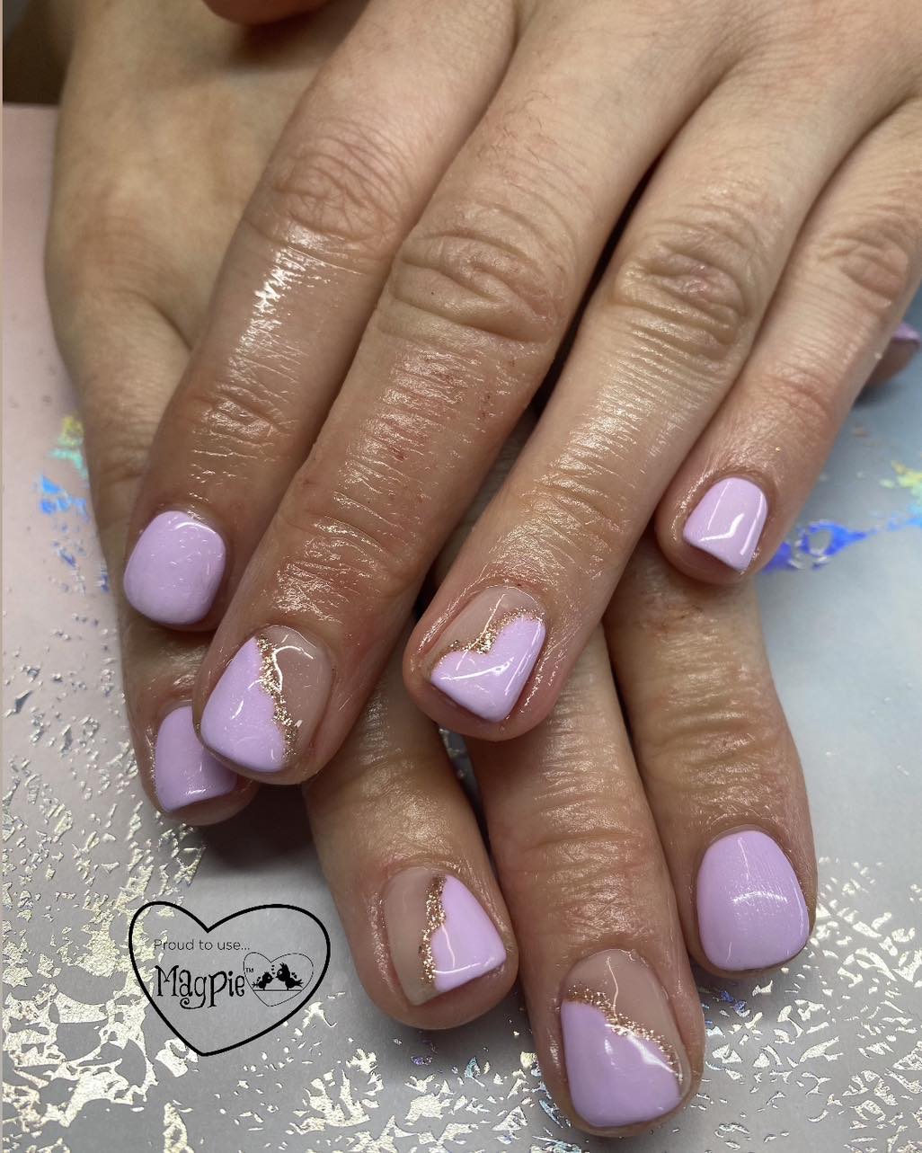 Lilac gel nails with rose gold glitter details